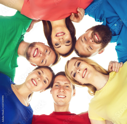 Large group of smiling friends staying together and looking at camera isolated on white background.