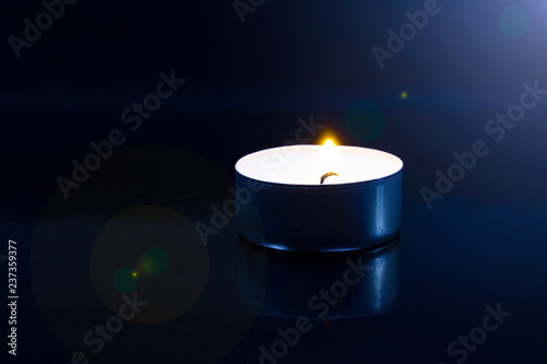 candle in the dark with reflection