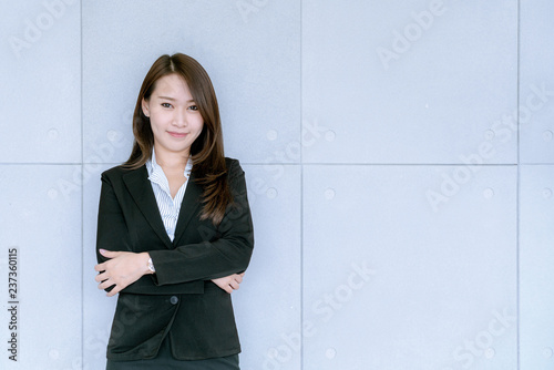 Asian beatiful young business woman in suit skirt using tablet to work about sales and marketing plan