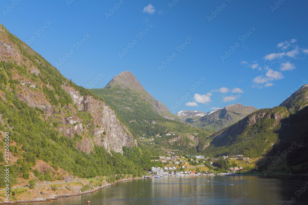 Sea gulf, mountains and settlement. Geiranger, Norway