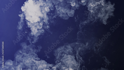 Blue toned . Fog and mist effect on black background. Smoke texture overlays. © Victor