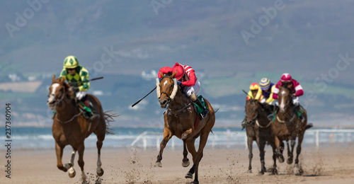 Horse racing action on the beach