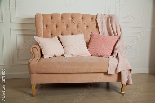 Home comfort. peach sofa with pillows and blankets.
