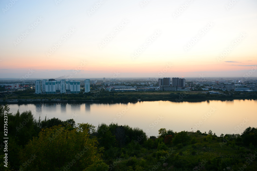 NIZHNY NOVGOROD, RUSSIA - AUGUST 28, 2018: View to Okskiy Bridge and lower city from Okskiy Syezd at time of sunset