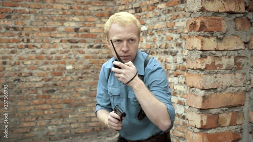 Security guard pursues a man with a gun in his hand.