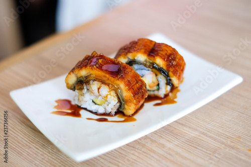 Anago (Grill Eel) or Unagi sushi with japanese sauce serve on white plate - Japanese traditional food concept for background or texture.