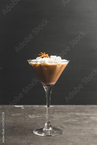 Chocolate martini with spices and marshmallow on the rustic background. Selective focus. Shallow depth of field. 