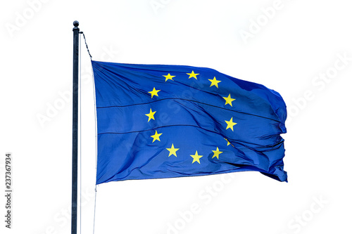 Flag of the European Union winding in the wind and hanging on a mast on white background.