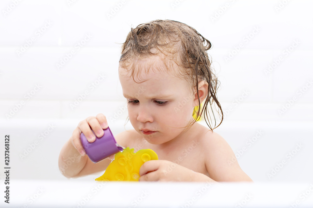 Cute little girl taking bath and playing toys Cute little girl taking bath and playing toys