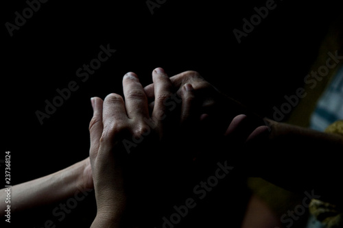 Young hands of a girl in the hands of an old grandmother