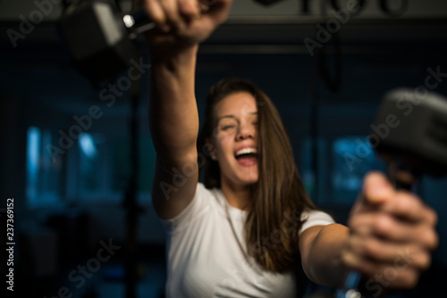 Happy successful woman in the gym