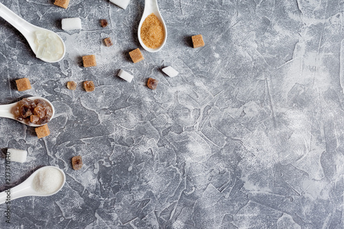 Various types of sugar, brown sugar and whiteon a gray background. copy spase photo