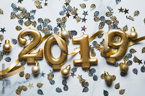 Happy new year 2019 gold background with confetti on a merble background photo