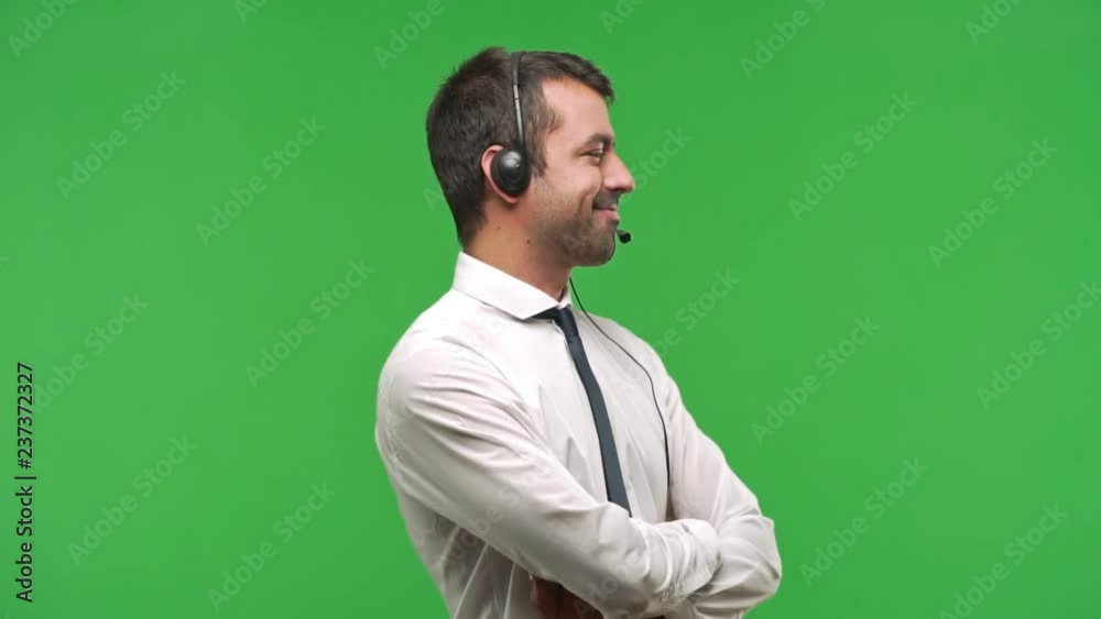 telemarketer man standing and looking to the side on green screen chroma key background telemarketer man standing and looking to the side on green screen chroma key background