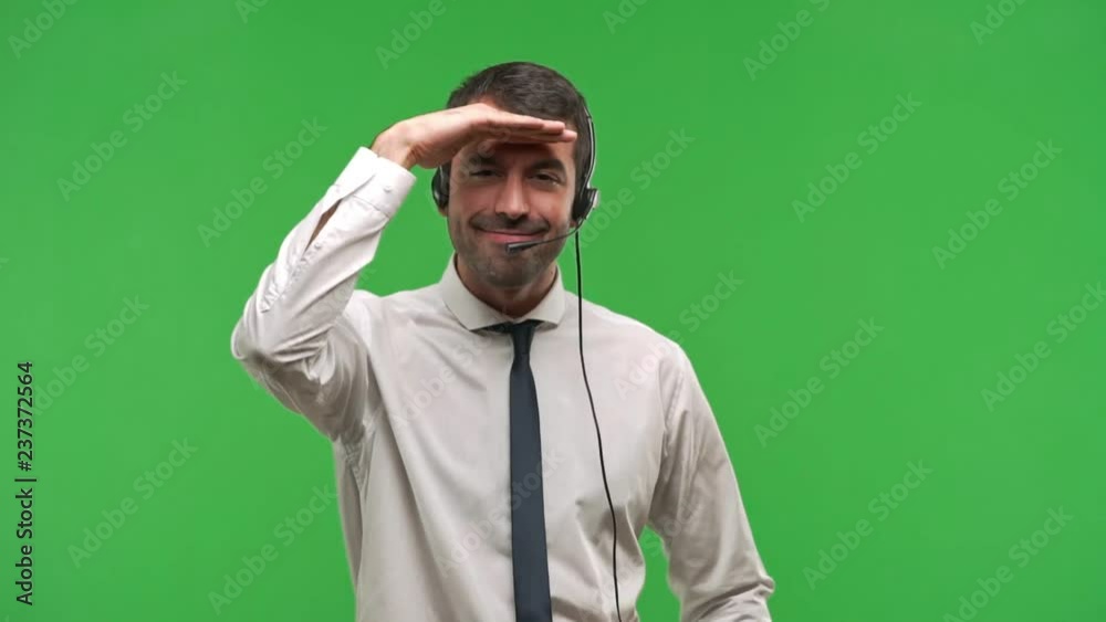 telemarketer man looking far away with hand to look something on green screen chroma key background telemarketer man looking far away with hand to look something on green screen chroma key background