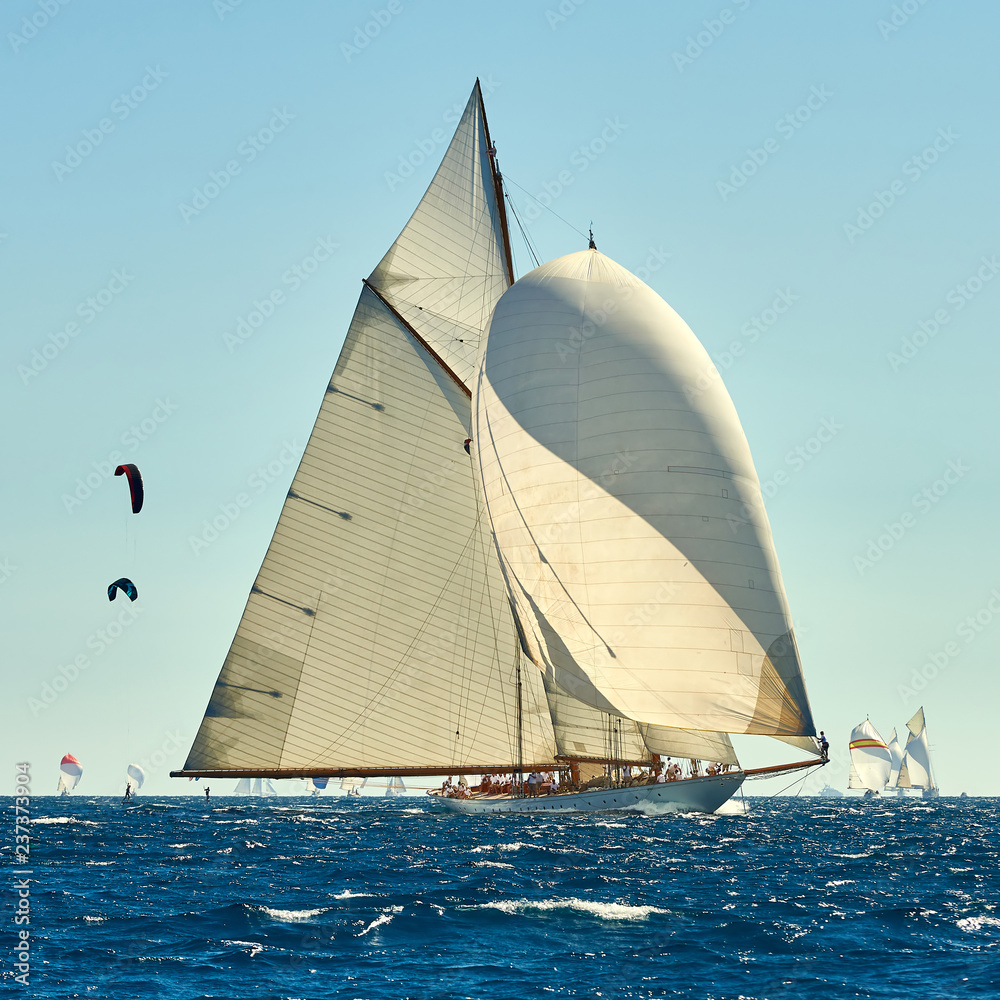 Obraz premium Sailboat under white sails at the regatta. Sailing yacht race
