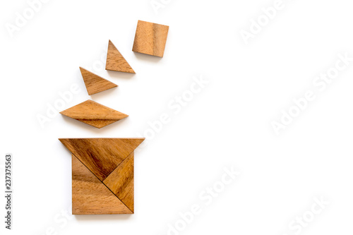 Wood tangram puzzle in magic hat shape on white background