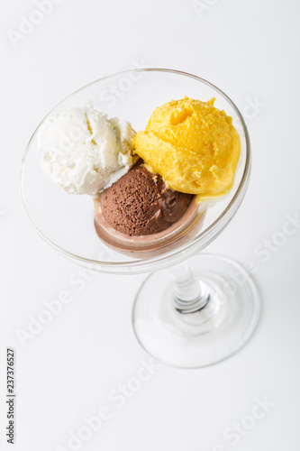 Three scoops of creamy flavored ice cream