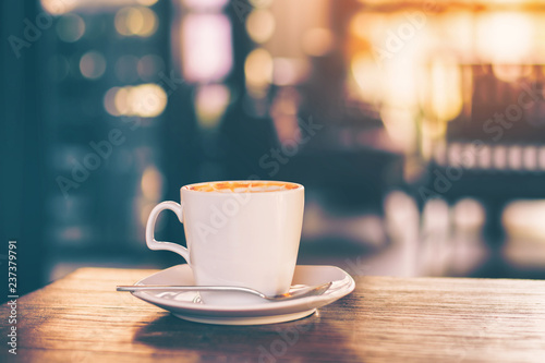 cup cappuccino coffee on wood table and vintage life stlye.