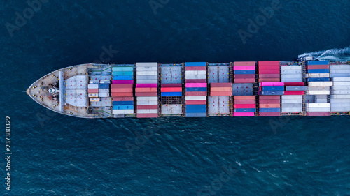 Aerial top view of cargo container ship vessel import export container in the ocean. © Yellow Boat