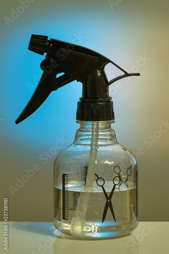 Spray bottle for hairdresser, transparent bottle with black nozzle, close-up
