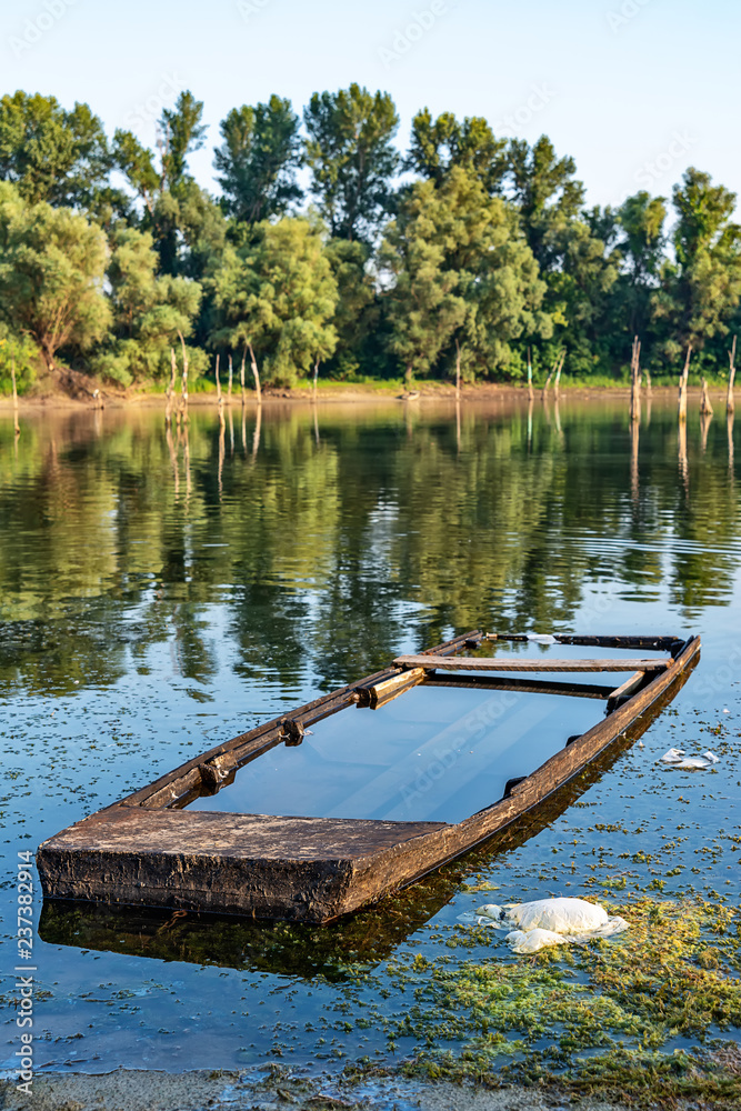 Naklejka premium Old abandoned and submerged boat