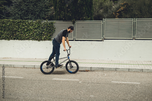 Guy riding his bicycle down the street