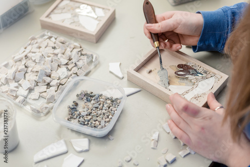 Hands Artist working on stones mosaic