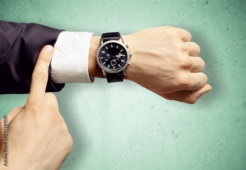 Businessman with hand watch on background, close-up