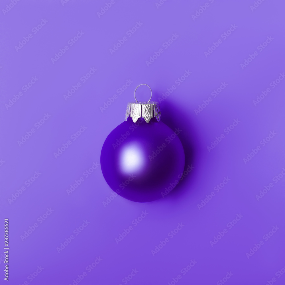 Christmas ball on Proton Purple. New Year greeting card with place for text. Christmas ball on Proton Purple. New Year greeting card with place for text.