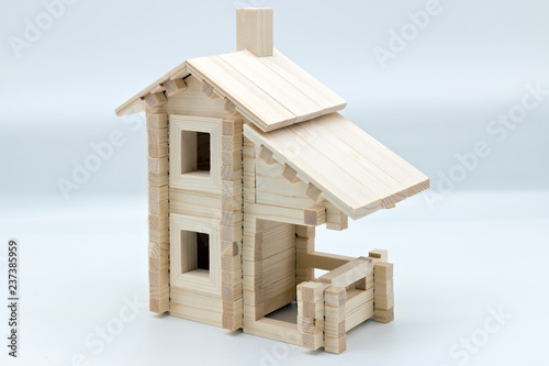 Toy wooden house on a white background (building model) photo