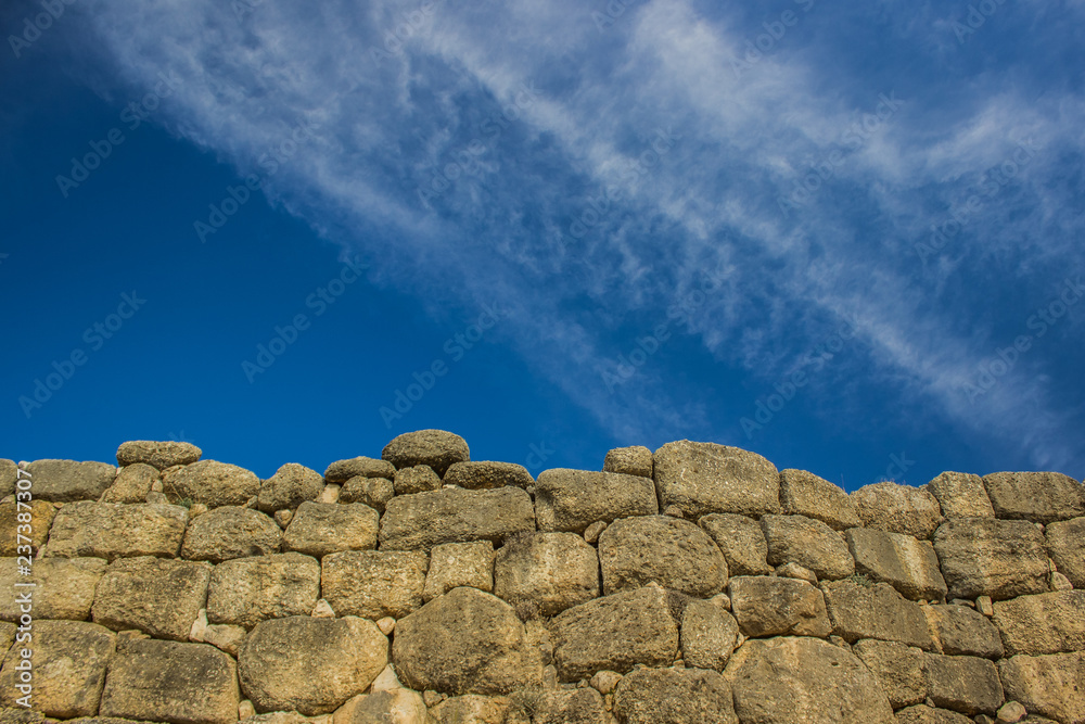 ancient old stone brick wall texture on blue sky empty background horizontal wallpaper concept with copy space ancient old stone brick wall texture on blue sky empty background horizontal wallpaper concept with copy space