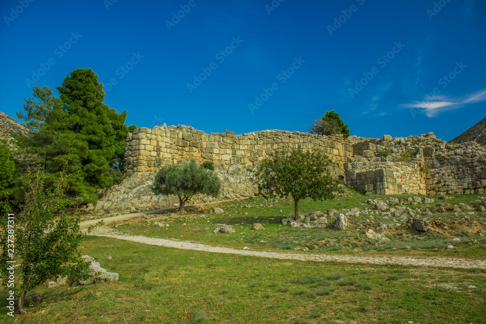 destroyed ancient wall ruins of ancient antique city in country side landmark highland valley space somewhere in Greece