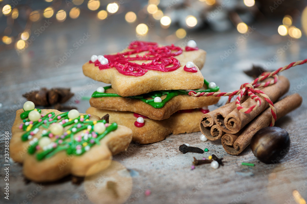 gingerbread in the form of Christmas trees, stars and red-green on a wooden background with cinnamon and star anise gingerbread in the form of Christmas trees, stars and red-green on a wooden background with cinnamon and star anise