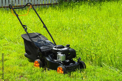 Modern gasoline powered grass mower on grass