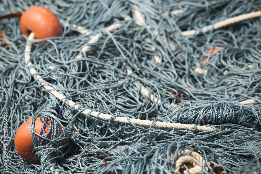 Fishing nets with red floats lay in port. Close-up Fishing nets with red floats lay in port. Close-up