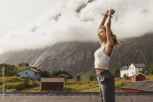 Woman with closed eyes exercising outdoors photo