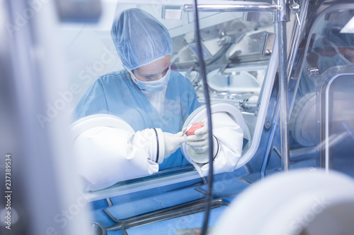 Scientist processing human tissue in insulator laboratory photo