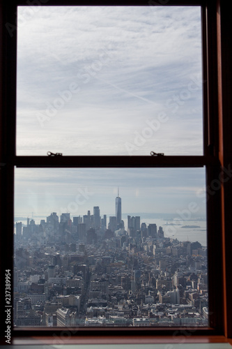 View of Lower Manhattan from The Empire State Building observation deck window.