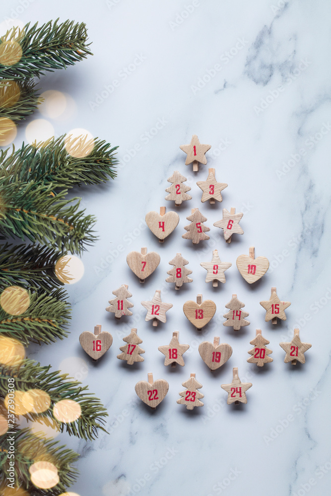 Festive Christmas advent calendar made from wooden shapes with tree branches