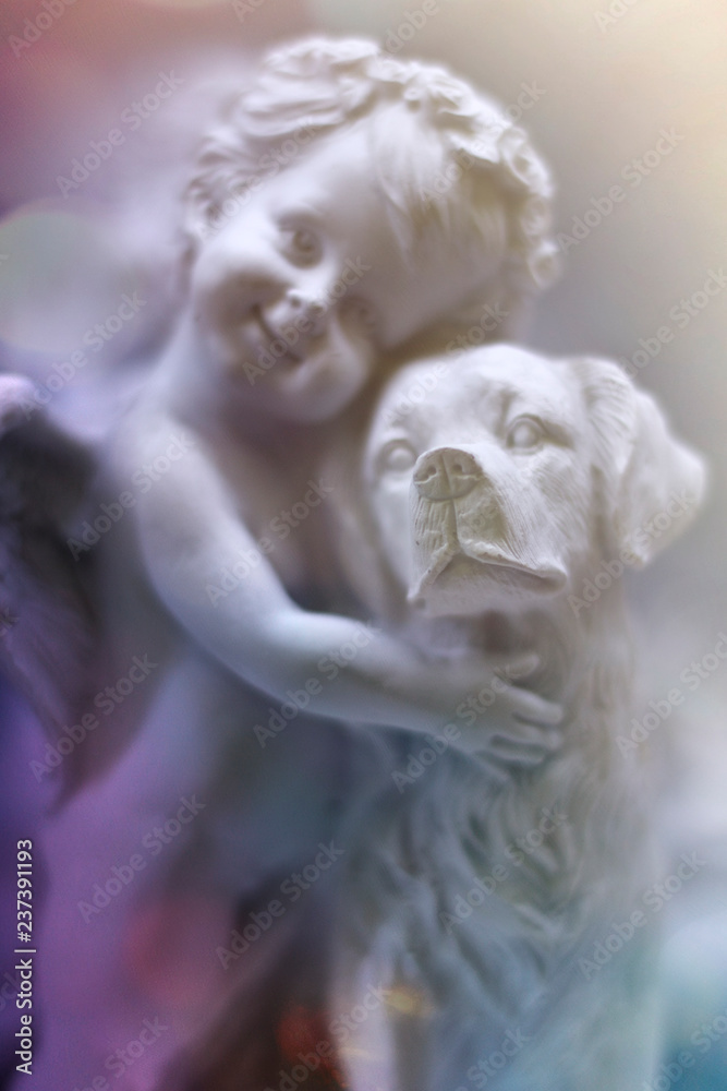gypsum angel hugs the dog