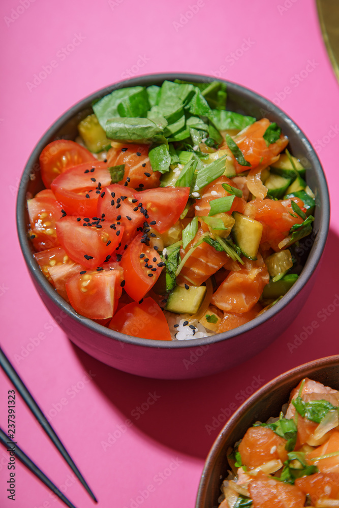 Poke bowl with marinated salmon and vegetable salad on rice Poke bowl with marinated salmon and vegetable salad on rice