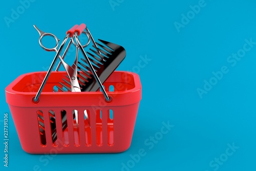 Obraz na płótnie Barber scissors with comber inside shopping basket