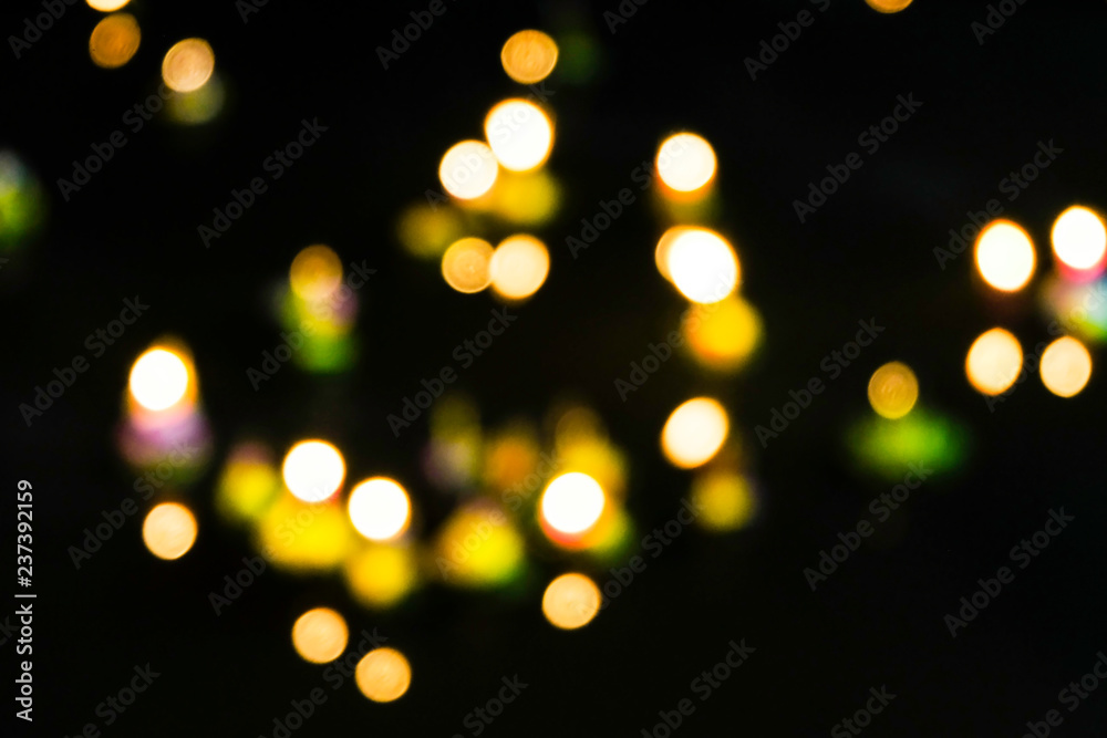 Blurred bokeh of light from incense stick and candles on Krathong in dark night, Beautiful scene of Loy krathong festival in Thailand, Culture of thai people to respect the river, Floating Krathong