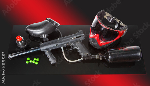 Paintball game equipment kit. Marker, mask, balls, grenade with paint.