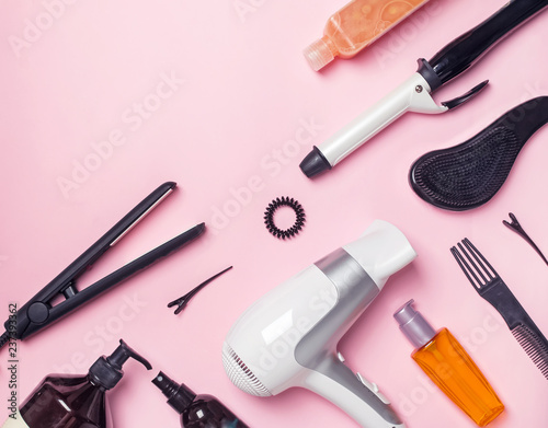 Fototapeta Naklejka Na Ścianę i Meble -  Hair styling and care items and products on pink background