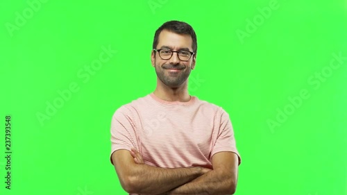 man keeping the arms crossed in confident expression  on green screen chroma key background