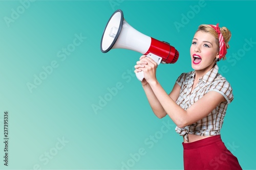 Portrait of woman holding megaphone, dressed in