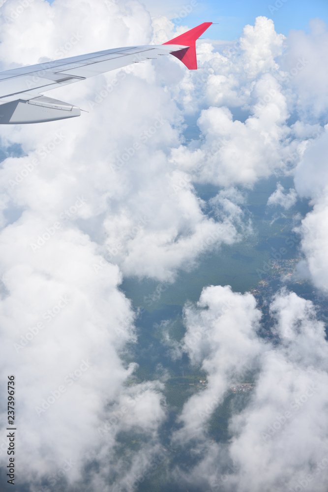 A beautiful moment of Cumulus clouds while an airplane passing by seeing beautiful landscape below. A beautiful moment of Cumulus clouds while an airplane passing by seeing beautiful landscape below.
