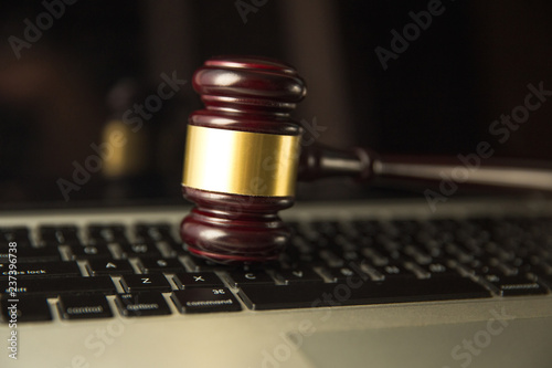 auction. Auction or judge gavel on a computer keyboard. 3d illustration.yber law or online auction concept. Judge gavel isolated on a computer keyboard tOnline op view, background. photo